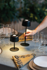 SC Hospitality Ailati 1+1 black cordless table lamps on a dining table with glassware and napkins