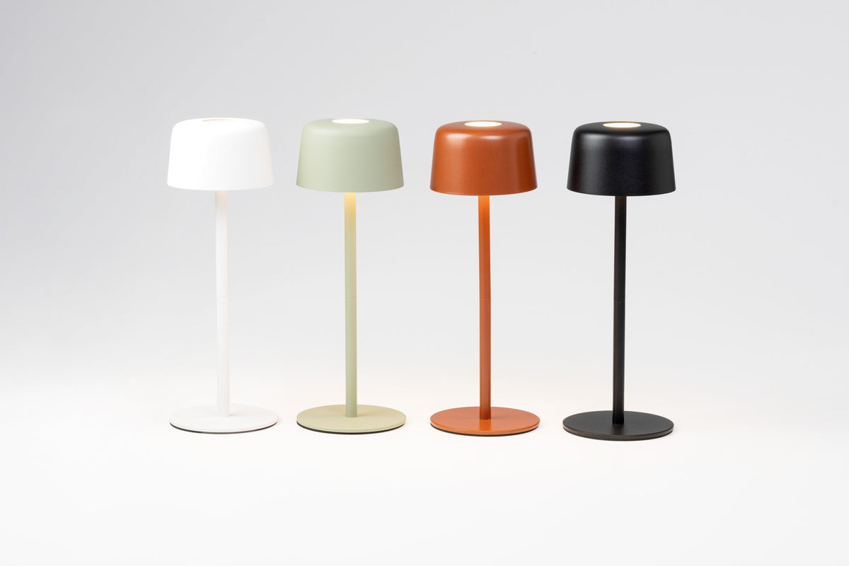 SC Hospitality Ailati 1+1 rechargeable table lamps in white, sage green, terracotta, and black on a white background.