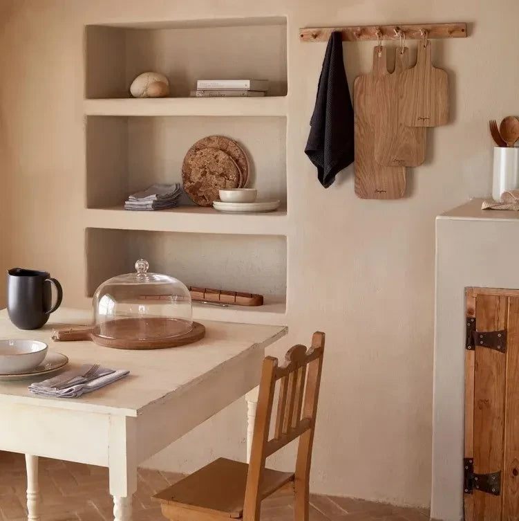 SC Hospitality Casafina glass dome with wooden base displayed on a rustic dining table in a neutral kitchen setting