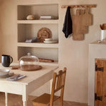 SC Hospitality Casafina glass dome with wooden base displayed on a rustic dining table in a neutral kitchen setting