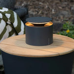 SC Hospitality grey cordless Push-Up table lamp with minimalist design on a wooden outdoor table