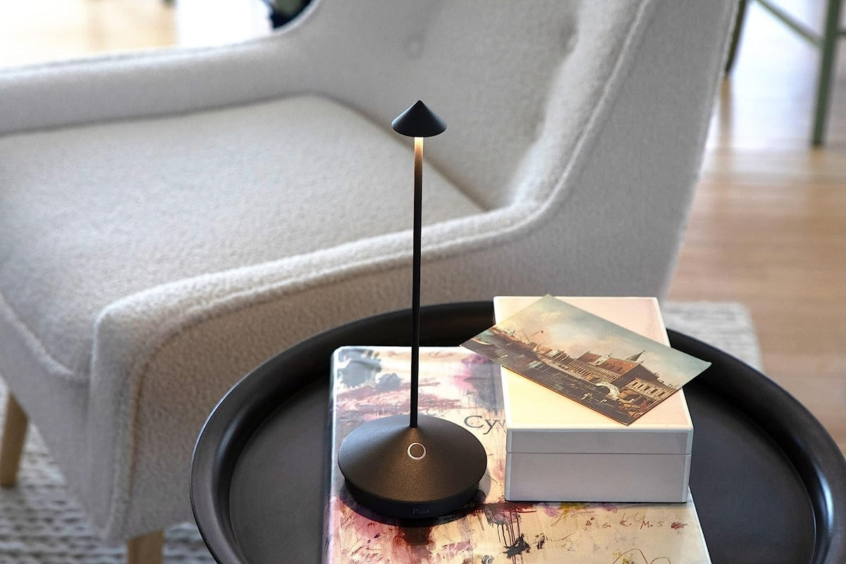 SC Hospitality Pina cordless dark grey table lamp with a sleek minimalist design on a small side table