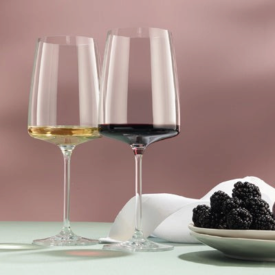 SC Hospitality Sensa crystal wine glasses with modern angular bowls, featuring white and red wine on a table setting.