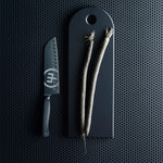 SC Hospitality WÜSTHOF Performer 20cm cooks knife with black DLC coating and hexagon grip next to vegetables on board
