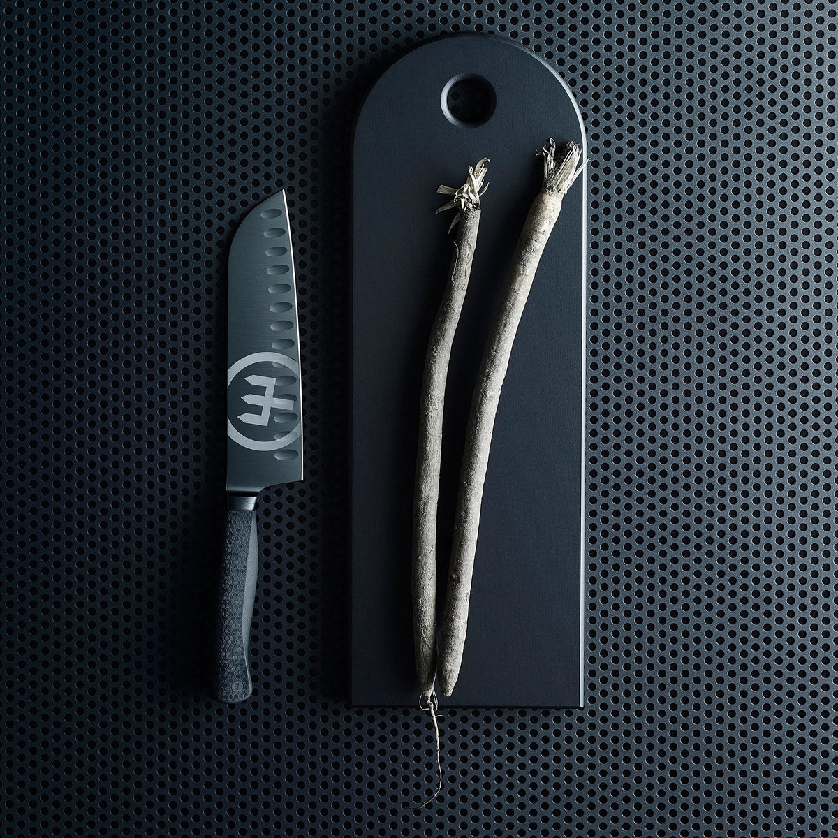 SC Hospitality WÜSTHOF Performer 20cm cooks knife with black DLC coating and hexagon grip next to vegetables on board