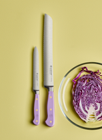 SC Hospitality Wüsthof Purple Yam serrated bread knife and utility knife set with ergonomic handles on yellow background