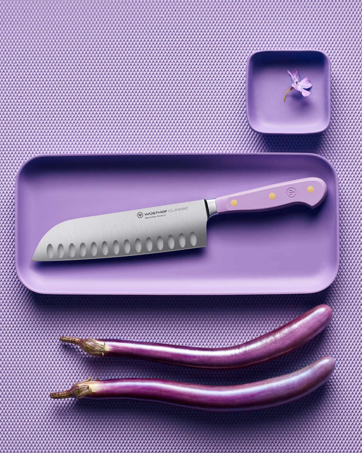 SC Hospitality Wüsthof 17cm Santoku knife with a purple synthetic handle, displayed on a matching purple tray.