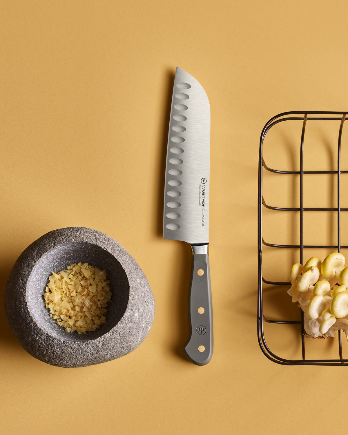 SC Hospitality Wüsthof 17cm Santoku knife with Velvet Oyster handle and granton edge on a yellow background